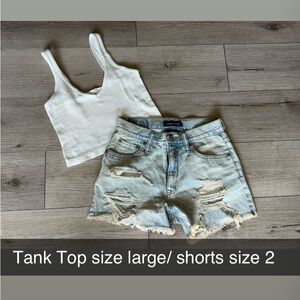 Super cute outfit! Ribbed V-neck cropped tank and distressed jean shorts.